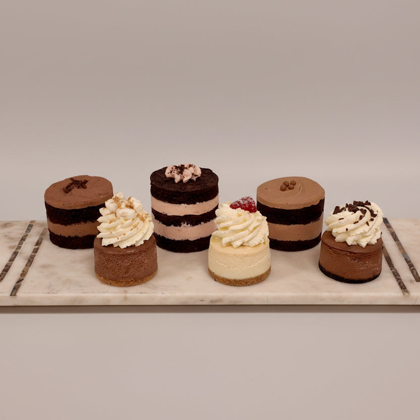 Mini cakes on a marble tray with a marble background